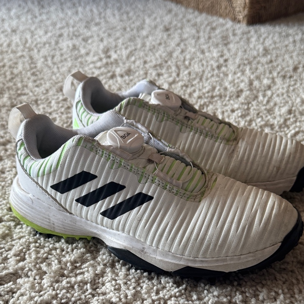 Adidas Kids White and Black golf shoes with Green Accents